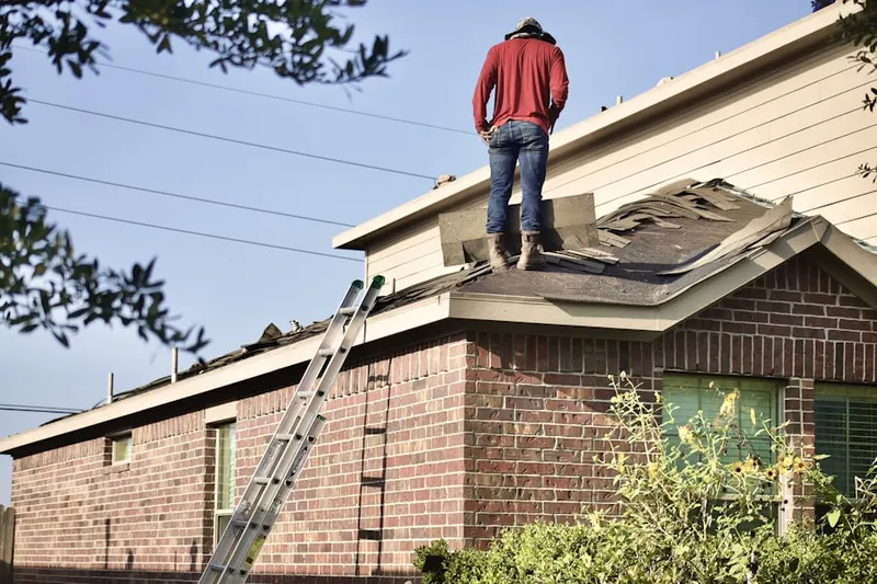 Professional roofer working on a residential roof in Sparta